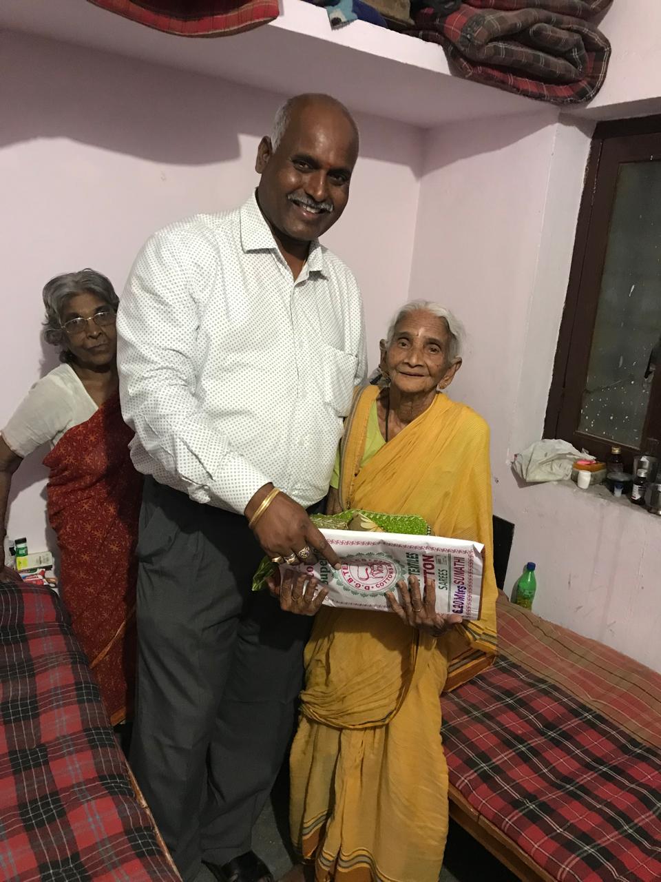 Resident receiving food and supplies at Vruddha Abhaya Trust